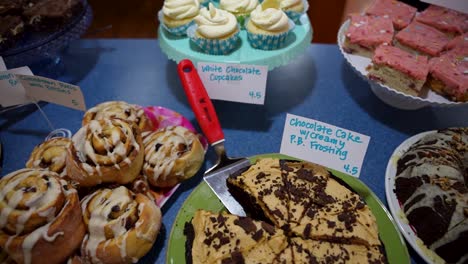 slow slider shot of a variety desserts and baked goods displayed for sale