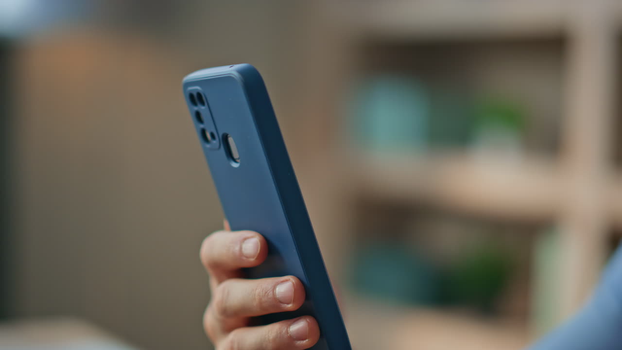 Unknown businessman hands tapping smartphone at workplace close up. Man browsing