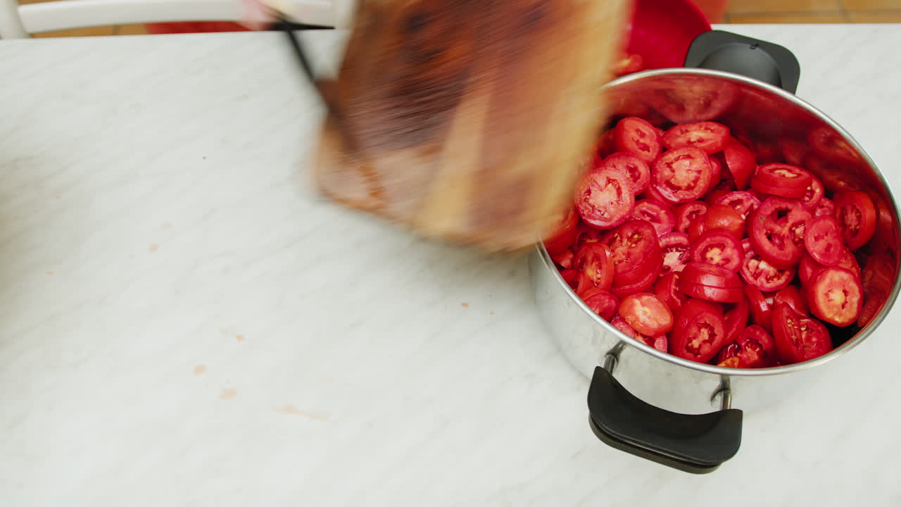 Man slicing tomatoes for red sauce in Sicily