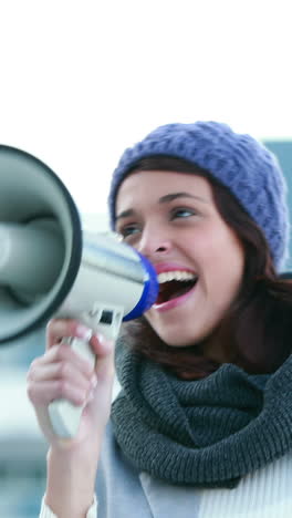 smiling woman shouting with megaphone