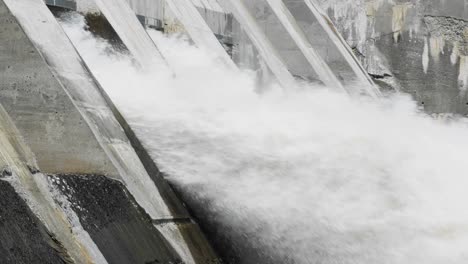 slow motion shot of powerful water flowing out of a large dam