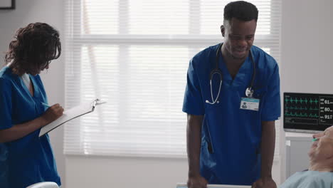 senior patient on bed talking to 2 african american doctor in hospital room health care and insurance concept. doctor comforting elderly patient in hospital bed or counsel diagnosis health.