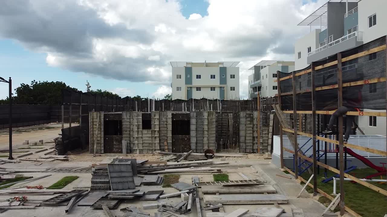 drone avanza hacia la zona de construcción residencial con estructuras base de edificios residenciales, la romana, república dominicana