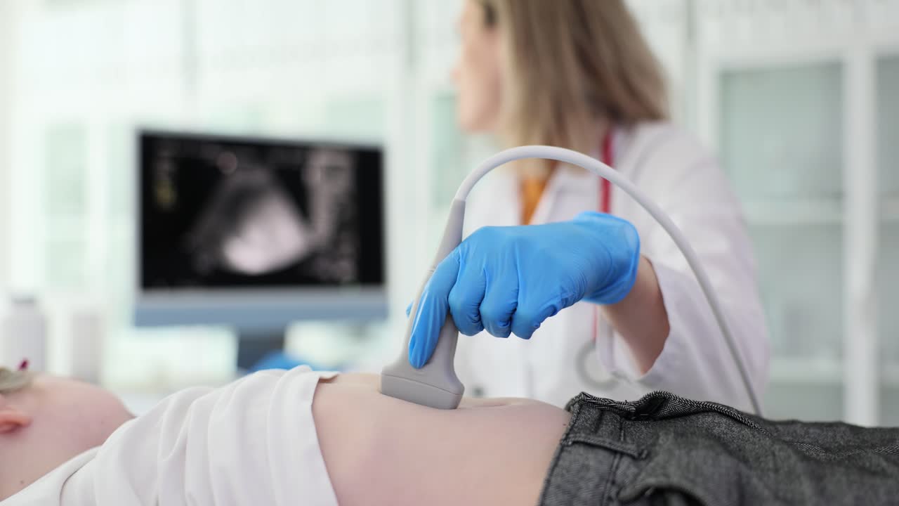 Medico controlla lo stomaco del paziente con apparecchiature ecografiche