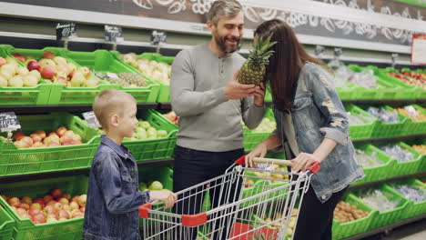 family shopping for fruits in a grocery store