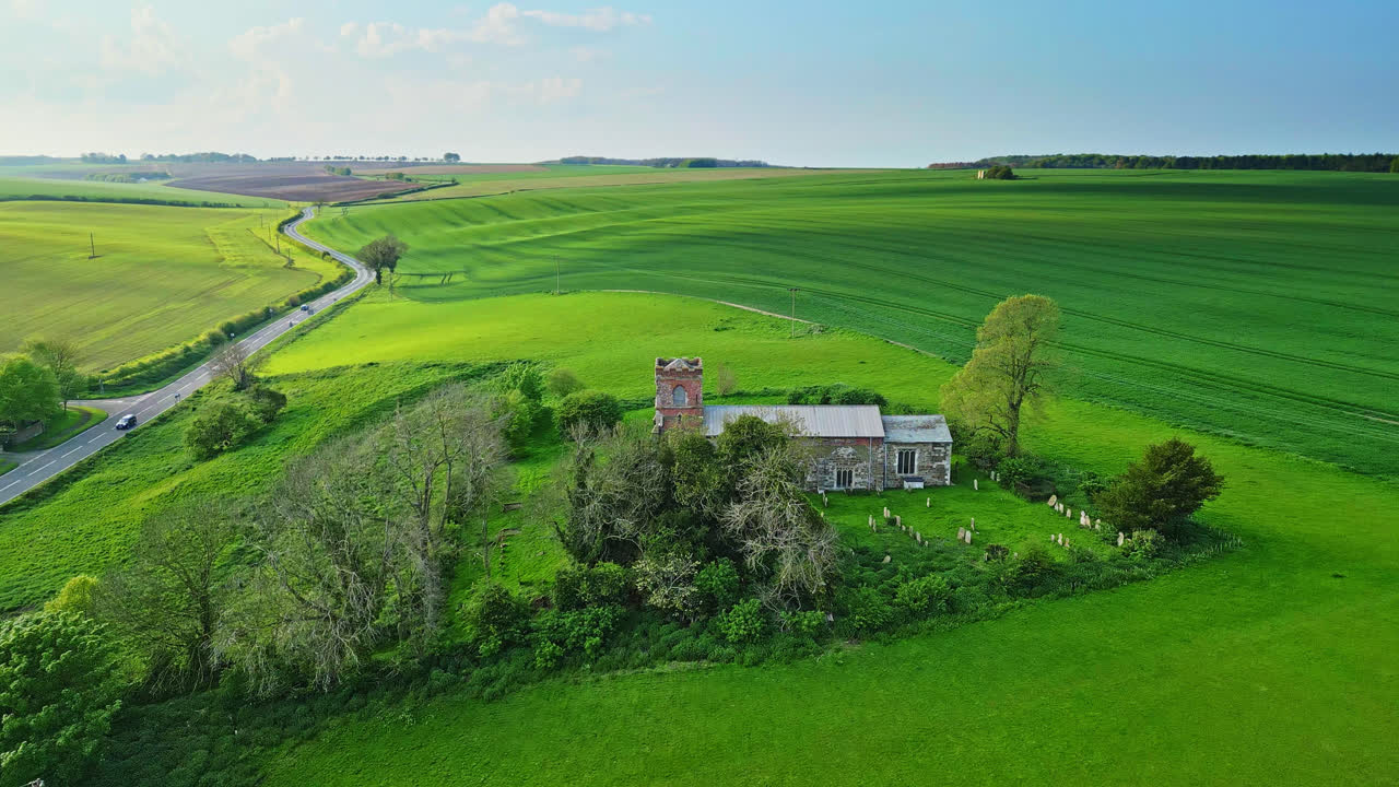 Aerial drone footage showcases Burwell village, formerly medieval market town&mdash;surrounding fields, aged red brick homes, and the unused Saint Michael parish church on Lincolnshire's Wold Hills