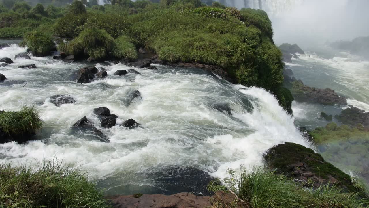 Panning of Iguazú waterfall in Brazil with rainbow in slow motion