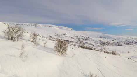 aerial view of snowy mountain hill at winter in haugastol, norway