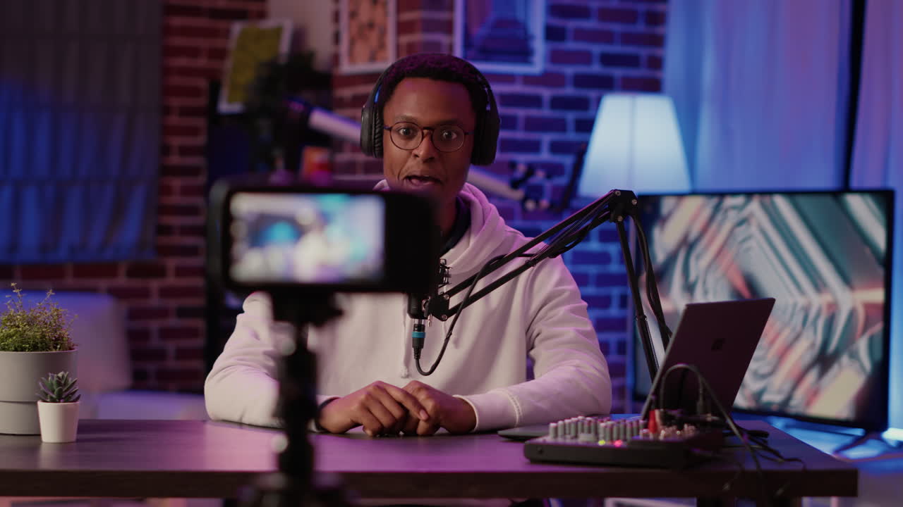 African american vlogger talking to audience counting to three while recording vlog using digital camera