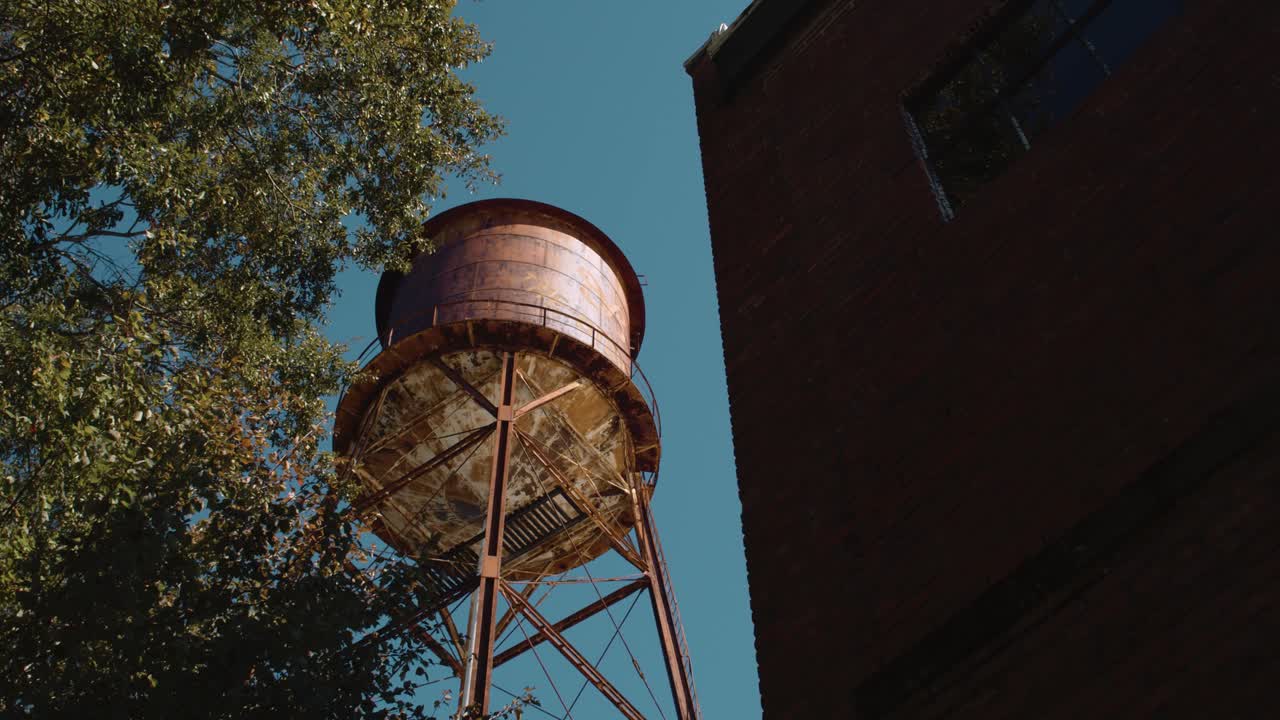 Low angle shot showing high tower of industrial factory,dolly view