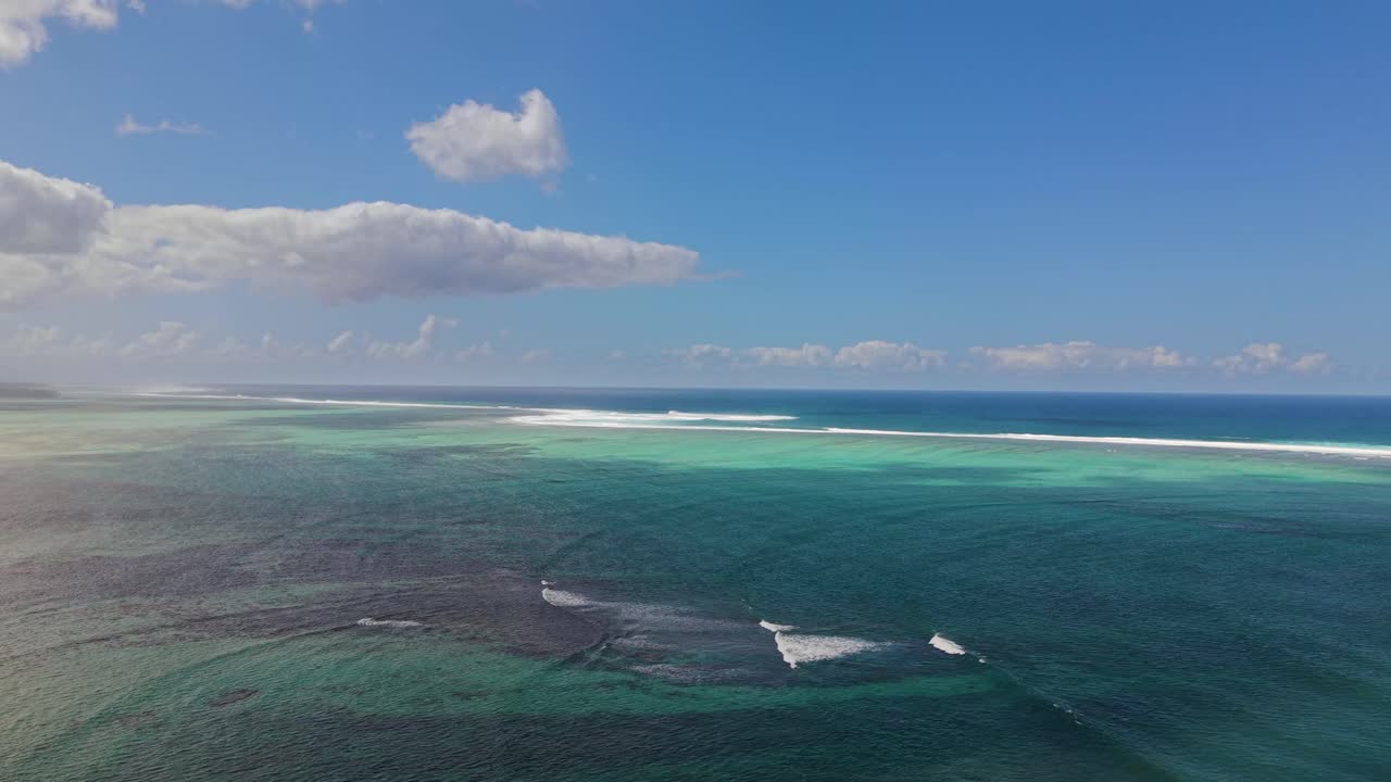Expansive drone shot of the Indian Ocean in front of the coastline of Mauritius