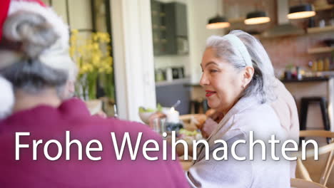 animation of frohe weihnachten text over diverse senior friends sitting at table at christmas