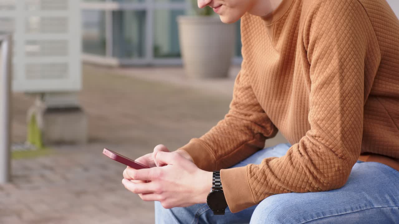 Reading message, man is lifting red smartphone, tapping and speaking into it, recording voice note