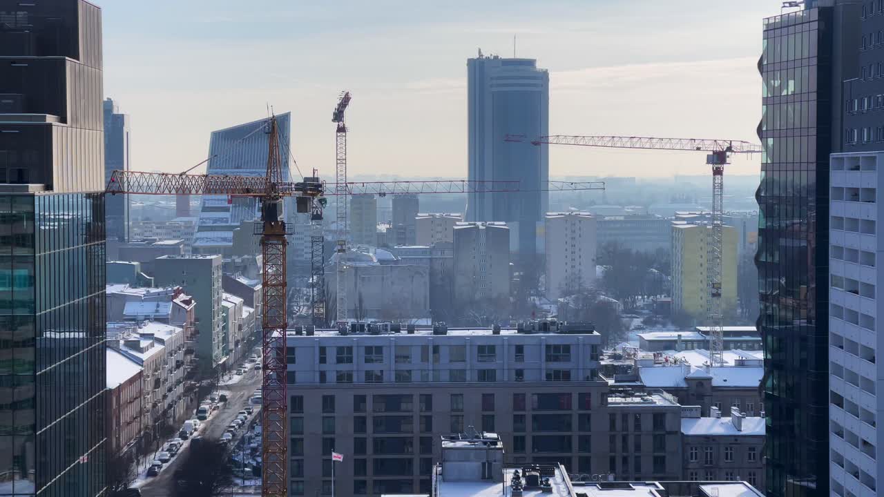 Winter Cityscape with Cranes Over Warsaw