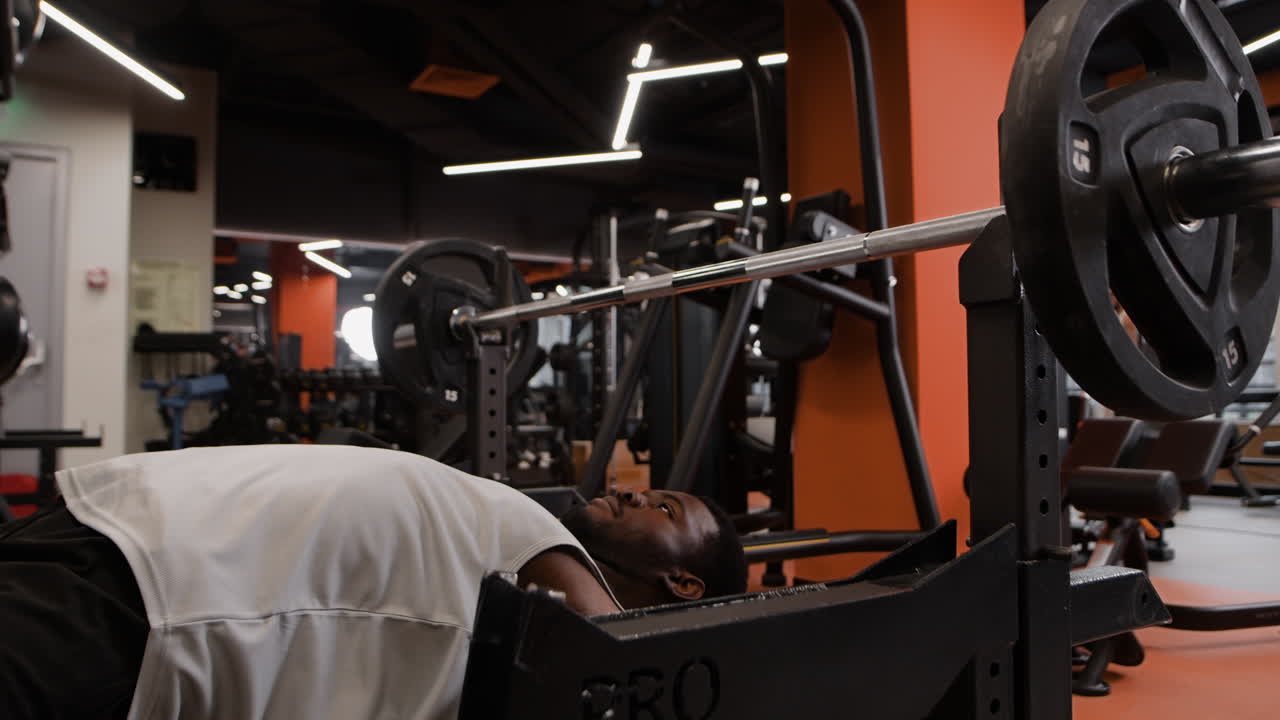 체육관 에서 벤치 프레스 운동 을 하는 남자
