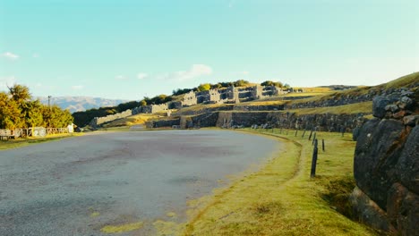 unique and breathtaking view of sacsayhuamán ruins with golden sunlight near cusco, peru. no tourists visiting, cinematic shot