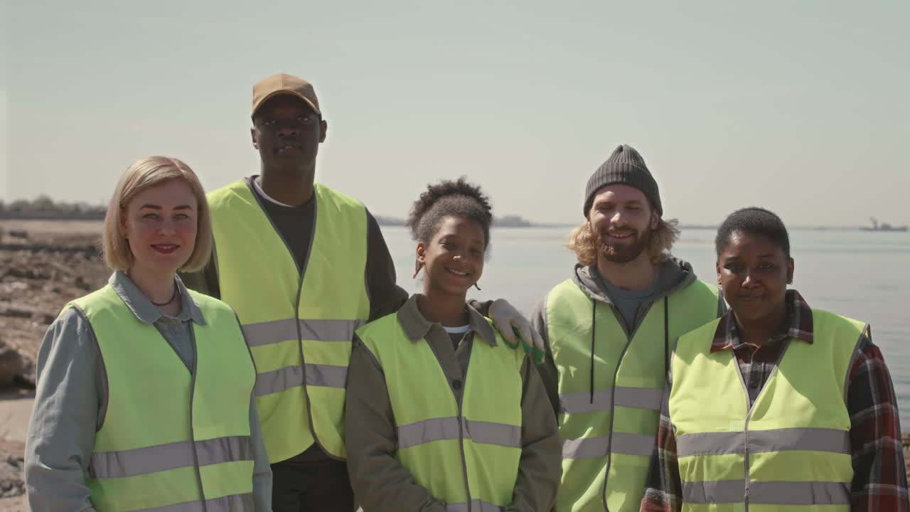 Group Portrait of Cheerful Environmental Activists on Coast