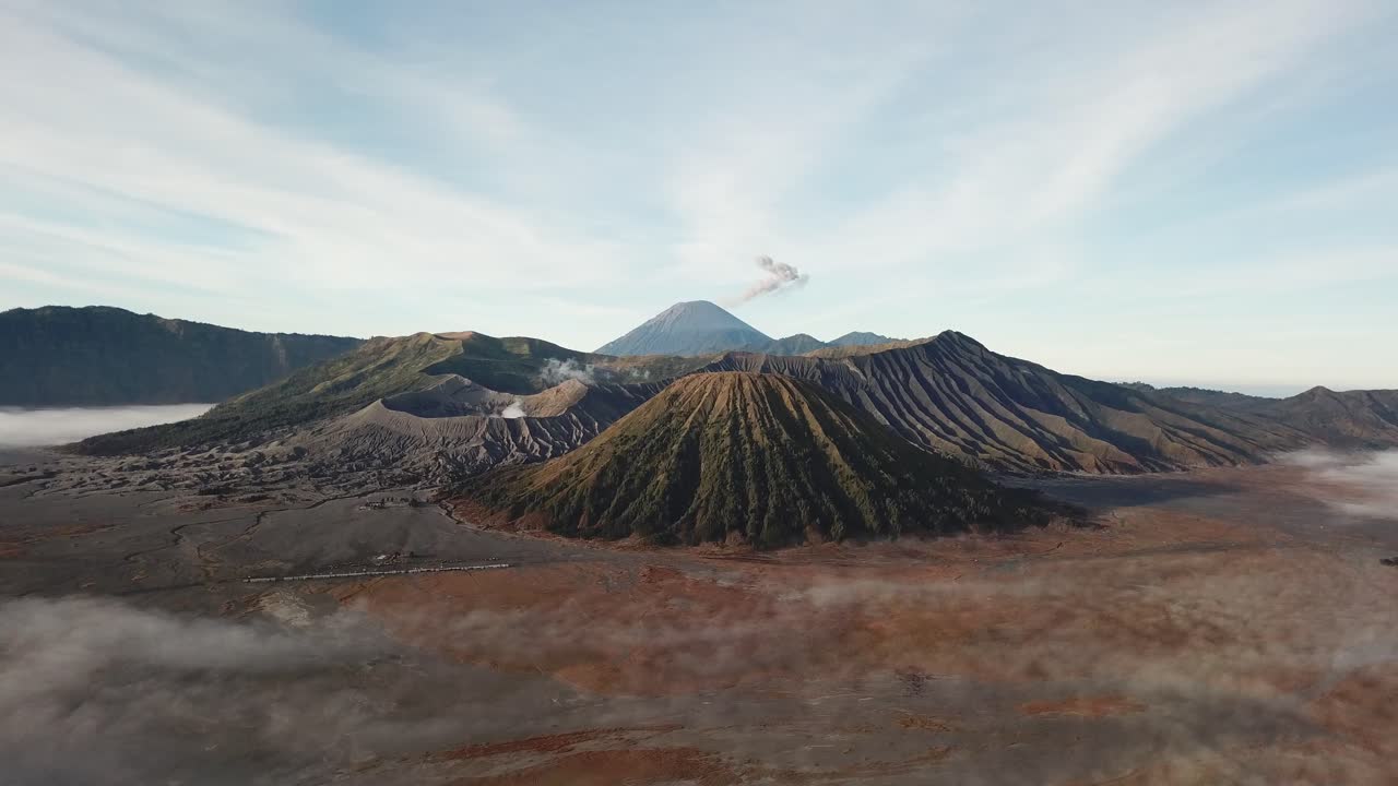 Beautiful view of Mount Bromo National Park in the morning with thin mist covering the area.