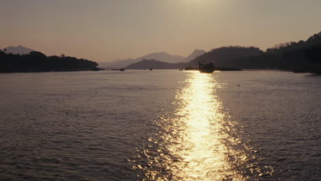 river sunset with boats and reflections
