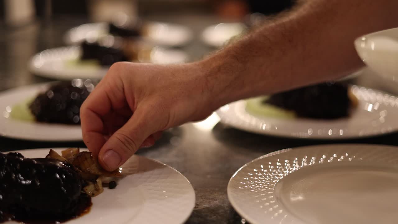 Chef Plating Dish With Cooked Mushrooms.