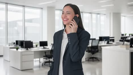 Happy-Indian-female-manager-talking-on-phone