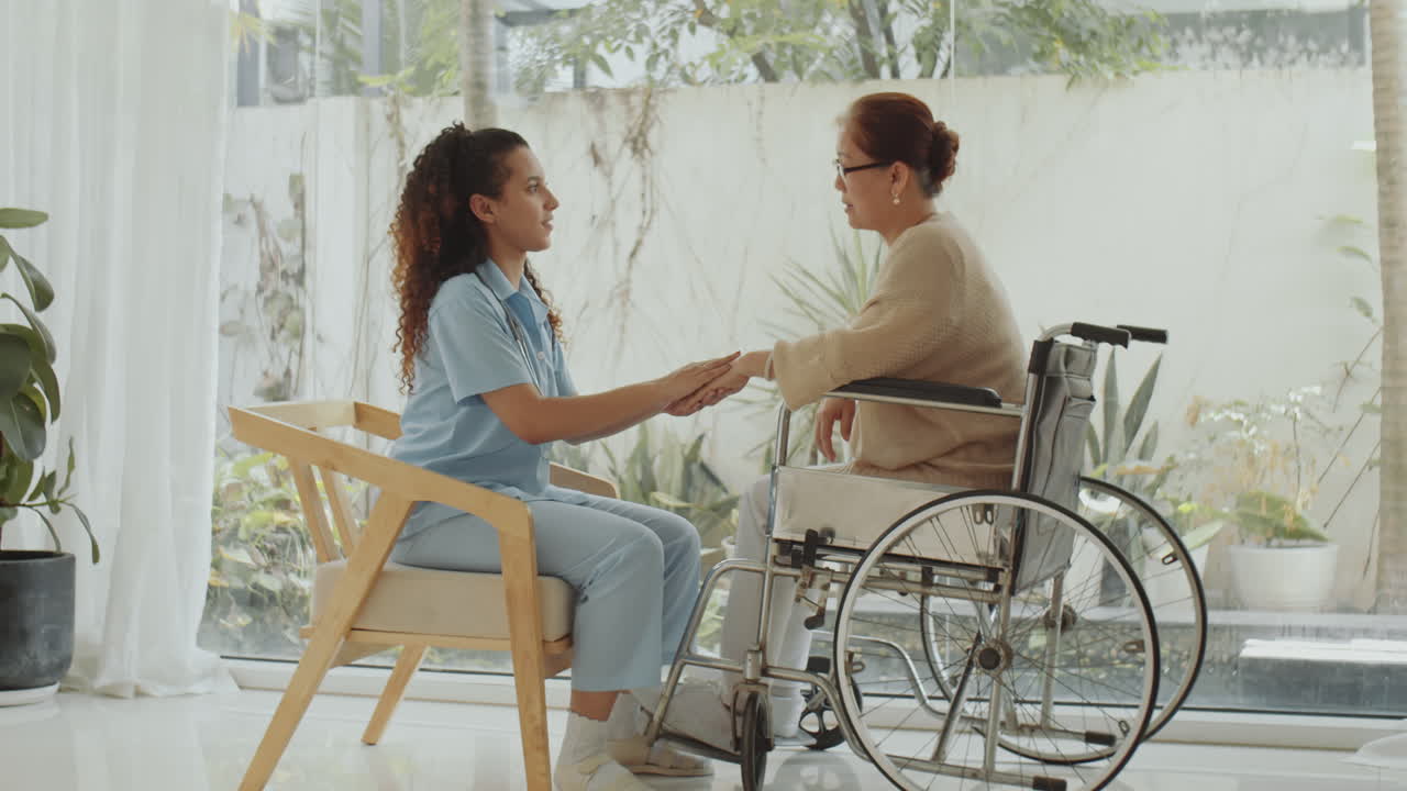 Nurse Caring for Elderly Woman in Wheelchair