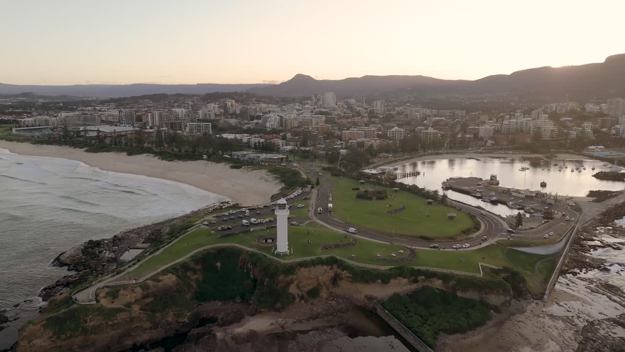 vista aérea de wollongong, nueva gales del sur, australia, mostrando la costa, el paisaje urbano y los paisajes circundantes durante una tarde brillante