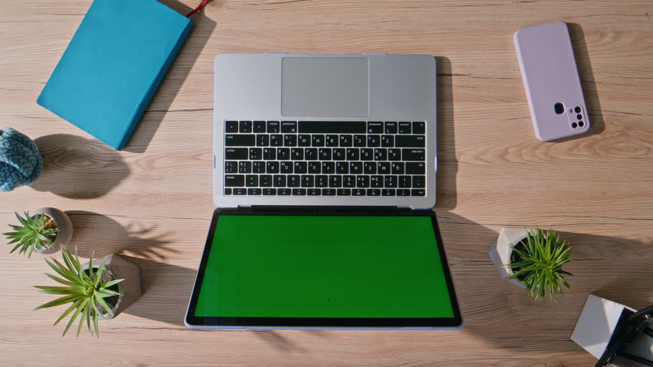 Modern chroma key laptop on wooden desk for remote work closeup top view