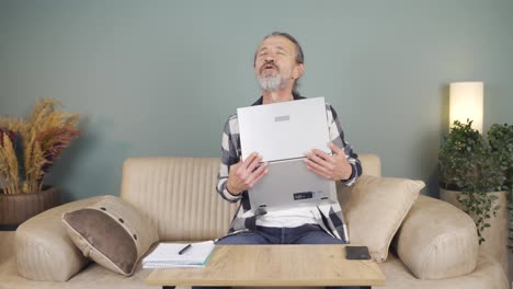 Man-joyfully-embracing-laptop.