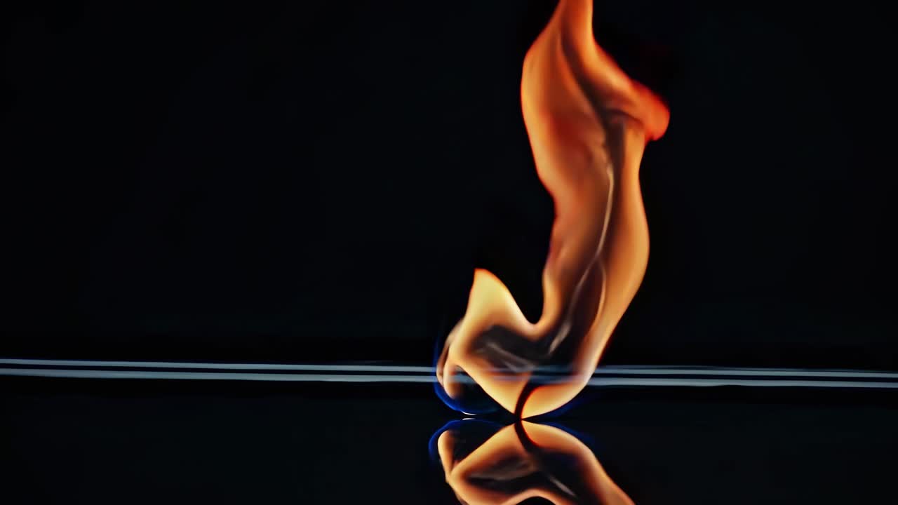 Close-up video of a flame reflecting on a glossy surface. Captured from a low angle
