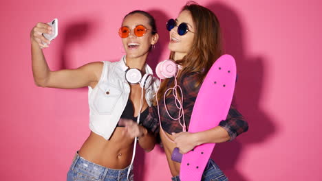 two friends taking a selfie with a skateboard