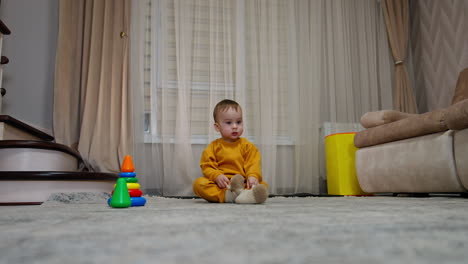 baby playing with toys in a living room