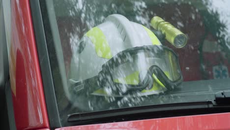 white firefighter helmet in windshield of vehicle, close up detail