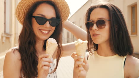 two friends enjoying ice cream on a sunny day