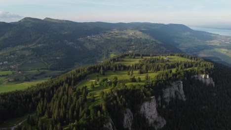 slow lowering aerial view high above the swiss countryside in sainte croix, switzerland on a sunny day