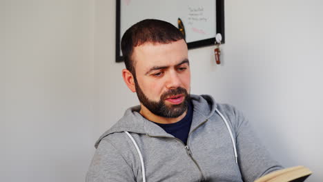 Bearded-Man-Happily-Reading-A-Book