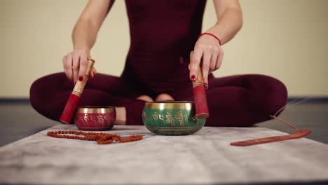 unrecognizable female hands clattering on some traditional buddhism pots.