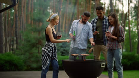 amigos relajándose cerca de la parrilla de bbq