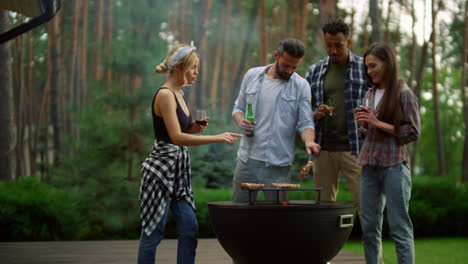 friends relaxing near bbq grill