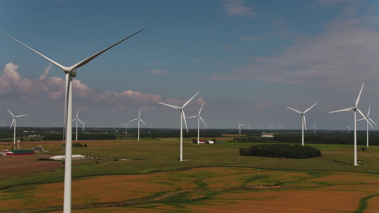 Wind Turbine Farm with Farmland Fields, Aerial Push in Shot