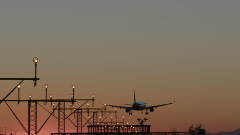 airplane landing at sunset