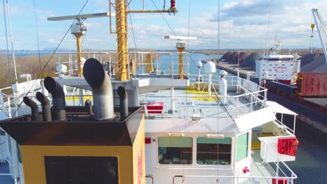 Large-ship-passing-through-a-narrow-water-canal-on-a-sunny-day