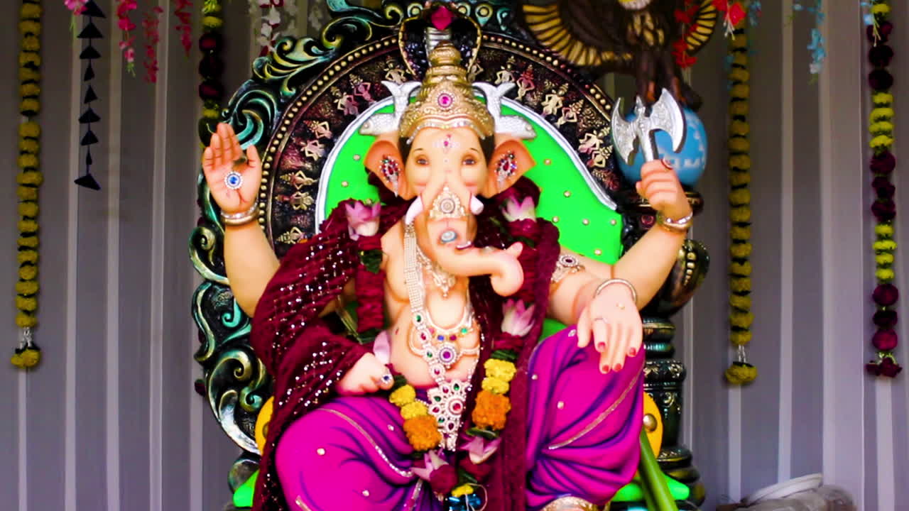 Beautiful Ganpati idol in decorated pandal for Ganesh Chaturthi celebration. Perfect for festival, culture and devotional stock footage needs