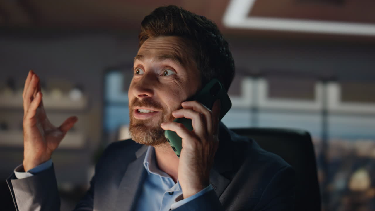 Cheerful businessman talking mobile phone closeup. Happy man work triumph call