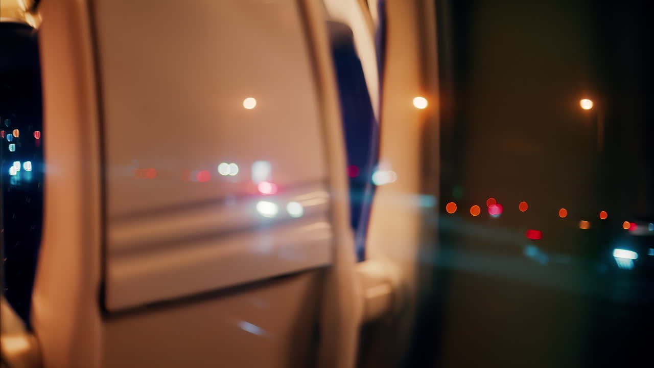 Close up of the window of a moving train with a blurry view