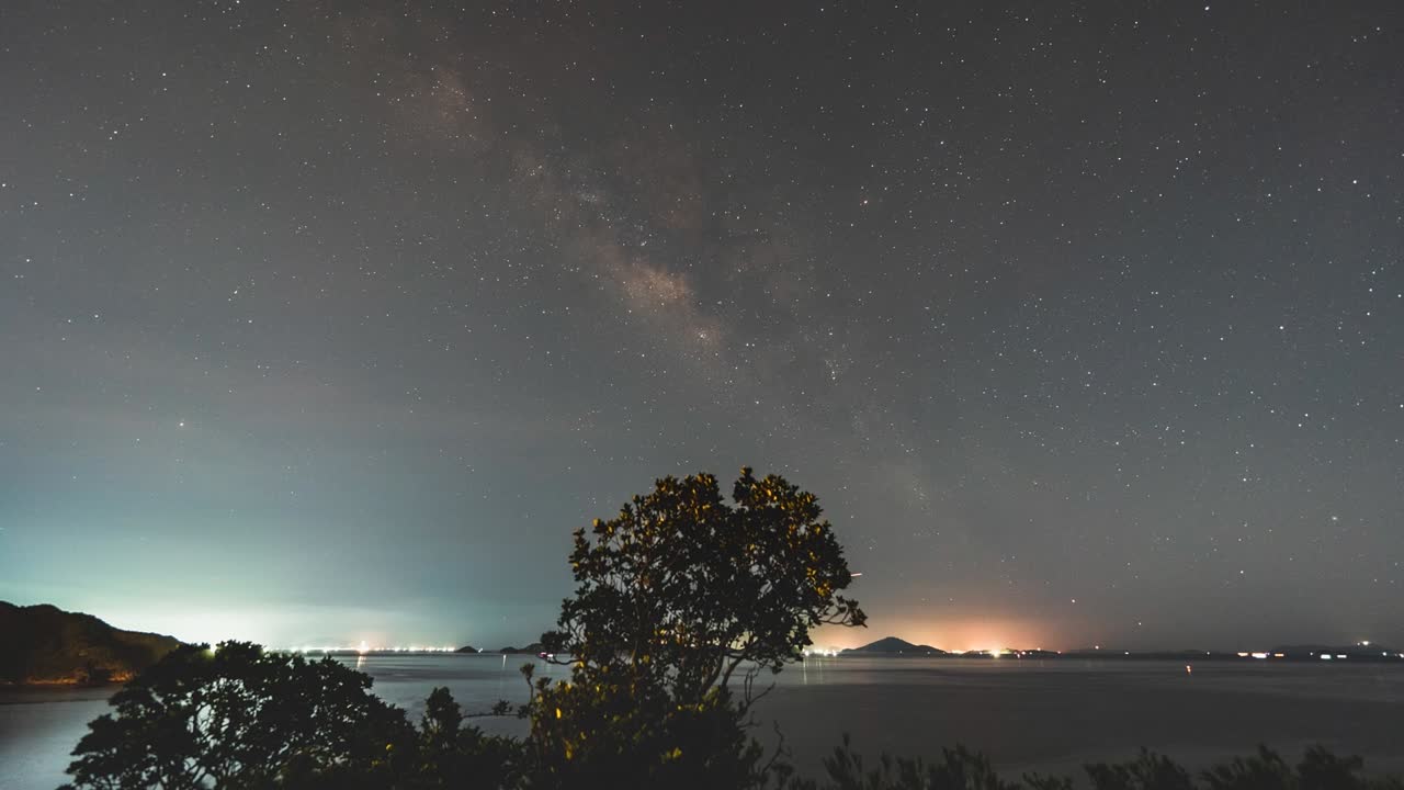 Timelapse view of magical milky way shooting stars. Beautiful imelapse night sky over Lantau island coastal Hong Kong.