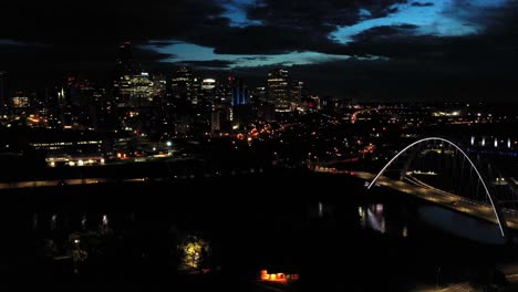 Aerial-drone-view-of-the-Edmonton-Walterdale-Bridge-over-the-North-Saskatchewan-River-during-a-summer-night-and-the-downtown-skyline-in-the-background