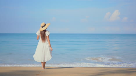 lonely female in summer dress on a sandy beach by tropical sea waiting somebody, romantic summer scenery, slow motion full frame