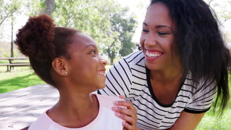 Slow-Motion-Portrait-Of-Smiling-Mother-With-Daughter-In-Park