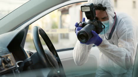 forensic photographer documenting a crime scene in a car